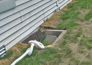 The ugly, old concrete window well of a Framingham crawl space