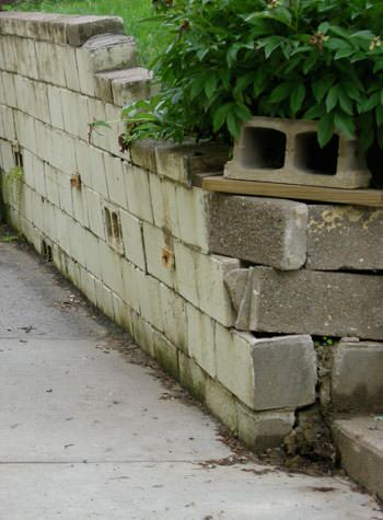 collapsing retaining wall with severe damage in Newton