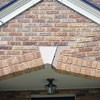 Major tuckpointing on a home archway over a door, with tuckpointing several inches wide that has failed on a Boston home
