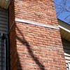 A tilting chimney on a Hingham home with a leaning, tilting chimney that was temporarily repaired.
