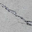 sinking outdoor concrete in need of mudjacking in South Boston