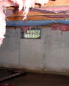 Massachusetts and Rhode Island crawl space with vents, showing mold, rot, and fiberglass insulation dripping off the ceiling.