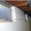 A foundation showing severe inward buckling along the windows in a Quincy home.