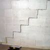 A diagonal stair step crack along the foundation wall of a Brookline home
