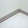 A partition wall separating from the floor in a Cape Cod home.