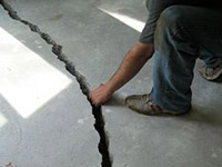 a severely damaged cracked concrete slab floor in Cape Cod