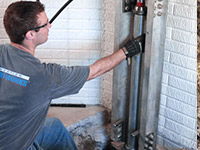 Driving foundation piers into the floor in Shrewsbury.