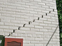 Stair-step cracks showing in a home foundation in Brookline