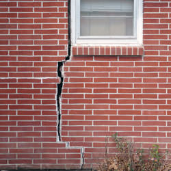 A foundation with a large crack that's wider at the top than on the bottom in New Bedford