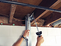 Straightening a foundation wall with the PowerBrace™ i-beam system in a Amherst home.