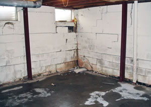 A failed, rusty i-beam foundation wall system installed in New Bedford.