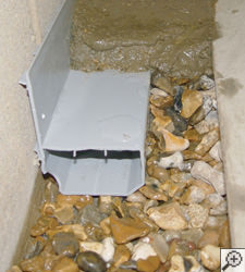 A no-clog basement french drain system installed in Bridgewater