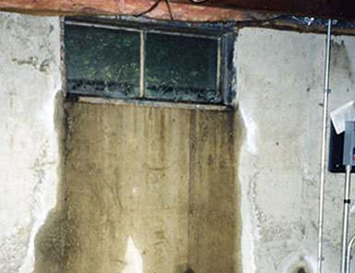Water pouring out from a basement window in Taunton